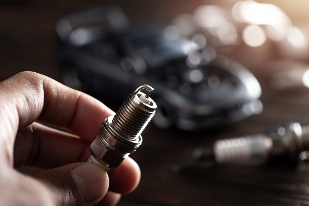 Replacing spark plugs to maintain engine performance.