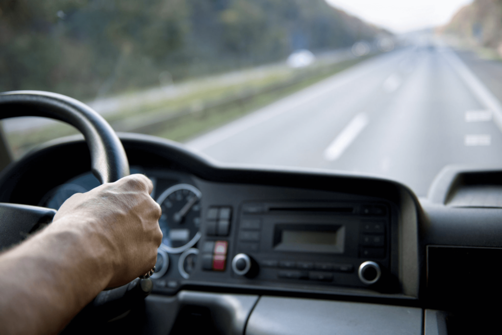 A man taking steering wheel and driving